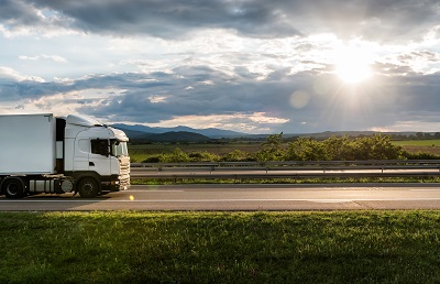 White truck is on highway - business, commercial, cargo transportation concept